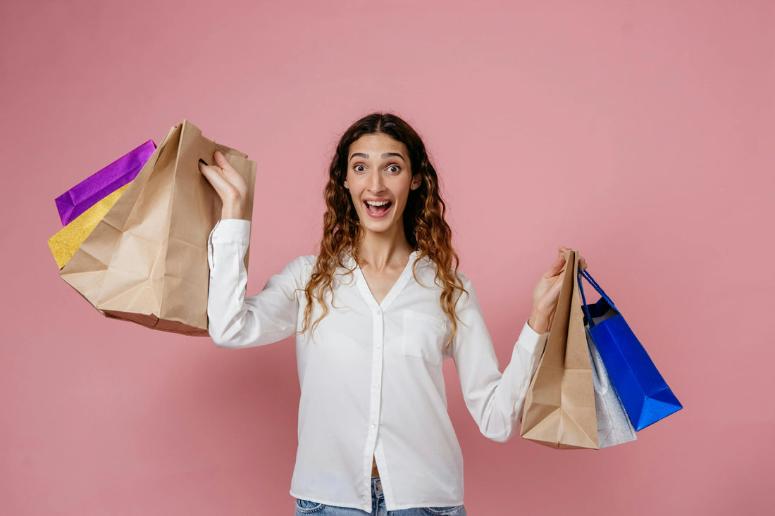 Woman holding many shopping bags in both hands after shopping